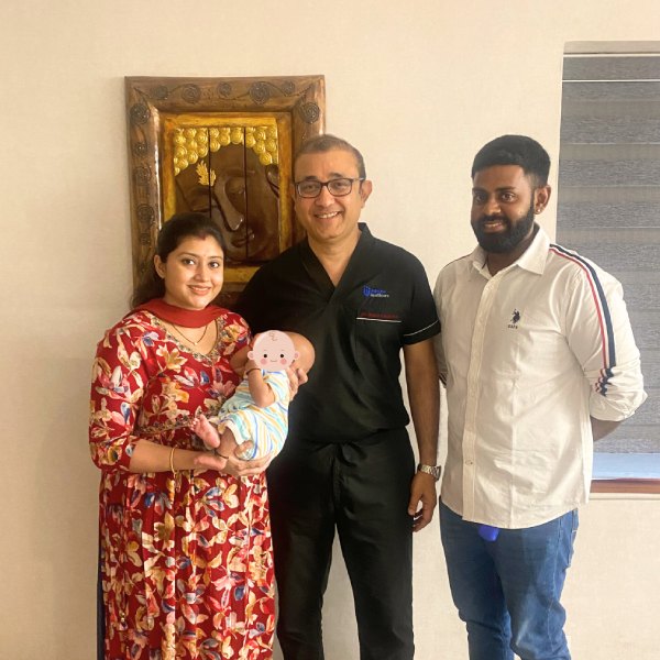Couple holding their baby after fertility support